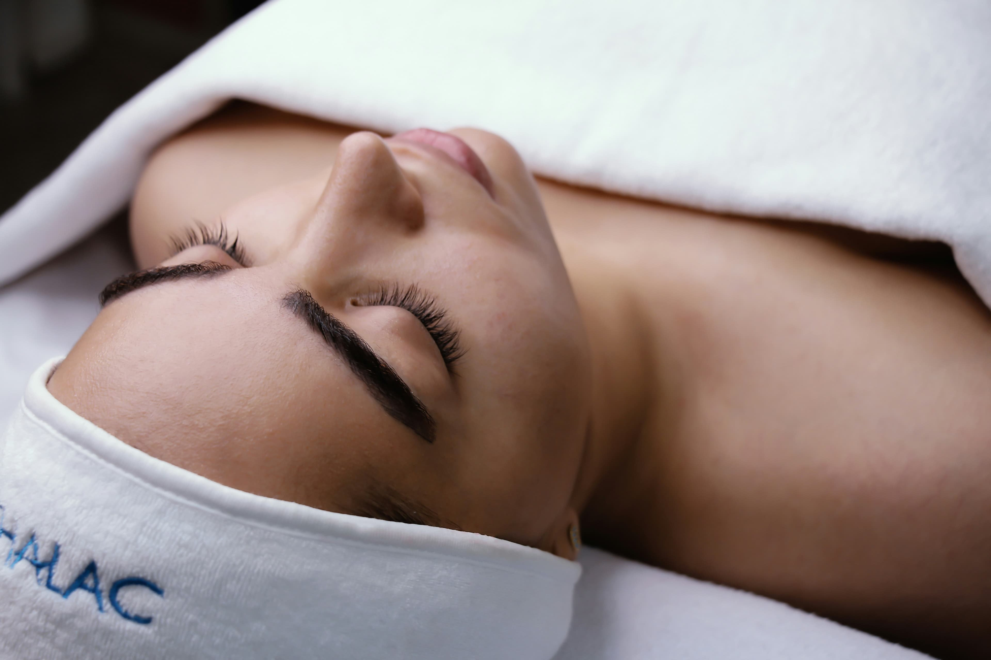 Mujer recostada con los ojos cerrados.
